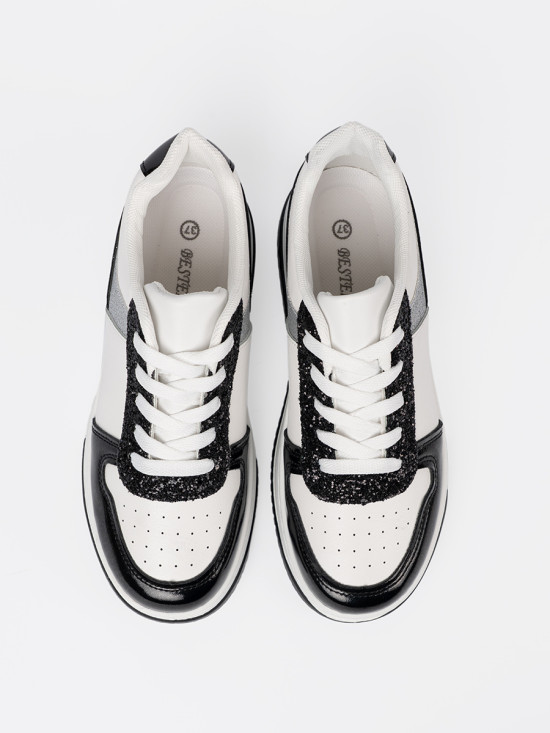 Czarno-białe sneakersy z połyskującymi srebrnymi detalami
