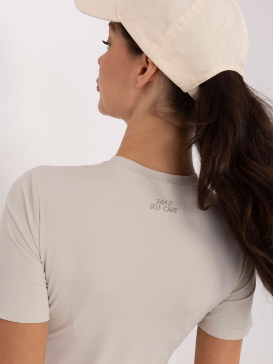 Jasnobeżowa gładka bluzka z krótkim rękawem