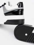 Czarno-białe sneakersy z połyskującymi srebrnymi detalami