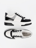 Czarno-białe sneakersy z połyskującymi srebrnymi detalami