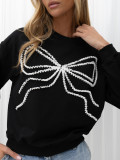 Elegancka czarna bluza z aplikacją